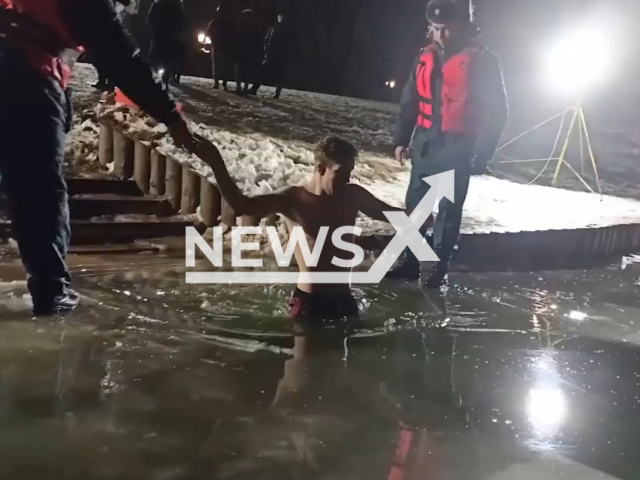 Man goes into water on the night of Epiphany, in Smolensk, Russia, in undated footage. More than two thousand people plunged into the hole on the night of Epiphany. Note: Picture is a screenshot from a video (Russian MIA Administration for the Smolensk Region/Newsflash)