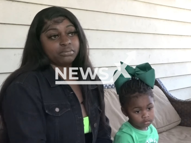 Shay Lee, the mother,  with London, the toddler slapped in the face by a day care director, in Glynn County, Georgia.
Note: Photo is a screenshot from video. (Newsflash)