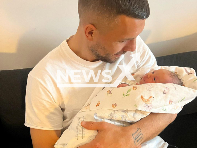 Ex Gunners player Lukas Podolski, 37, poses with his newborn daughter Ella, undated photo. The little one was born in Poland on Friday, Jan. 20, 2023. Note: Private photo. (@lukaspodolski/Newsflash)