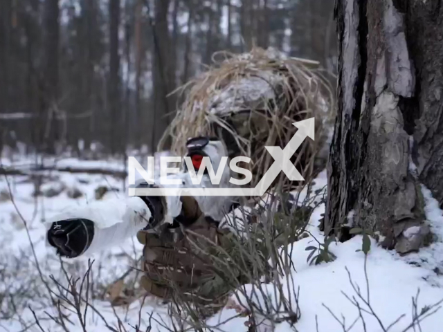 Ukrainian troops show off sleek winter camo gear as troops hide in snowy forest in Ukraine in undated footage. The footage released by the First Presidential Brigade on Tuesday, Jan. 24, 2023.
Note: Picture is screenshot from video. (@NGU3027/Newsflash)