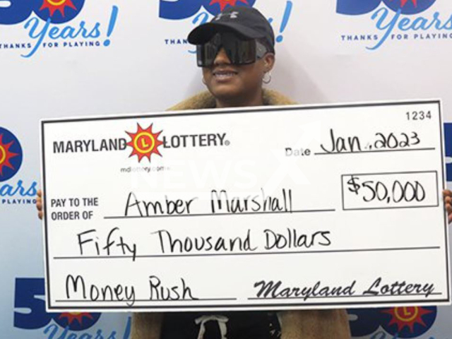 Amber Marshall, 28,  poses with with 50 thousand dollars wining check, undated.  She bought the scratch off ticket in Westminster, Maryland , USA, because her mother told her an itchy hand meant money was coming. Note: Licensed photo.  (Maryland Lottery/Newsflash)