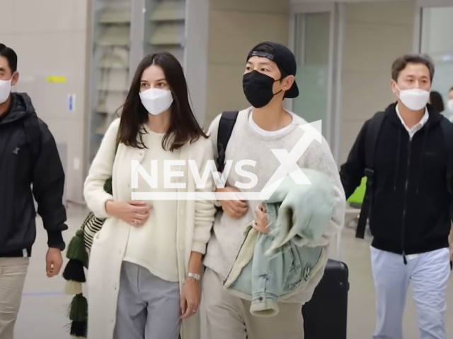 Song Joong-ki, 37,  and  Katy Louise Sanders, 38, walking, in December, 2022. He announced  that they are married in a letter on Monday, Jan. 30, 2023, and she is pregnant with the couple's first baby.
 
Note: Photo is a screenshot from a video. (Newsflash)