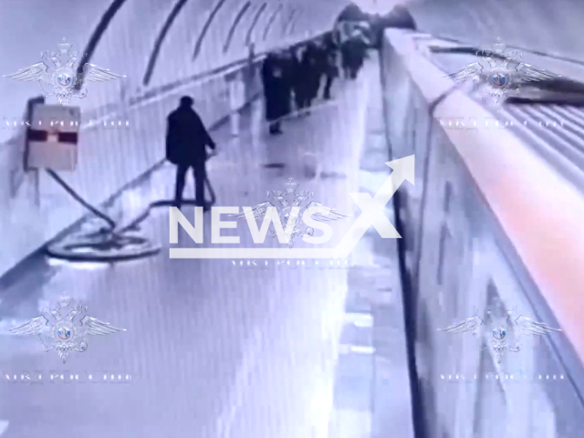 Man waters an electric train at Alekseevskaya metro station on the Kaluzhsko-Rizhskaya line, in Moscow, in undated footage. The man was subjected to an administrative arrest for a period of 10 days for petty hooliganism. Note: Picture is a screenshot from a video (@77police/Newsflash)