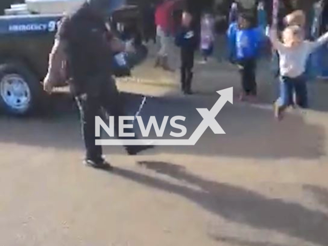 Officer Wilson from the Richland Police Department jumps rope with a little kid, in Richland, Mississippi, in undated footage. The Richland Police Department made a funny remark on Twitter that the officer needs jump roping lessons from the kid. Note: Picture is screenshot from a video. (@_richlandmspd/Newsflash)