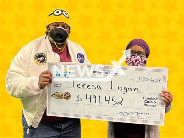 Teresa Logan and her husband pose with wining lottery ticket check, undated. Her husband reminded her to buy the ticket and  now they can retire after winning USD 491 451 on a Cash 5 ticket. Note: Licensed photo.  (NC Lottery Official/Newsflash)