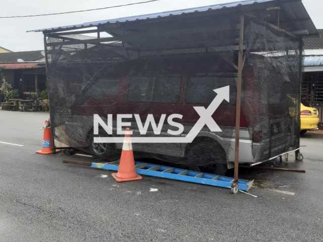 Picture shows a man-made shed built in the middle of a neighbourhood road to  park  a van in Kuantan, Malaysia, on  Sunday, Jan. 29, 2023. A notice for immediate removal was issued by the council.
Note: Government photo.  (@majlisbandarayakuantanofficial/Newsflash)