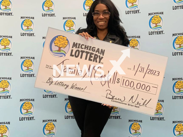 Jamila McCaskill, 44, poses with her lottery win check, undated. She won USD 100 thousand (GBP 82 thousand) after she randomly decided to play a lottery game on her phone. Note: Licensed photo.  (Michigan Lottery/Newsflash)