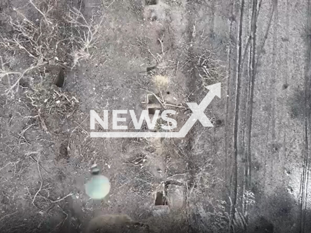 Bomb falls on Russian soldiers hiding in foxholes in a field area in Ukraine in undated footage. The footage was released by the 22nd battalion of the Ukrainian Ground Forces on Friday, Feb. 3, 2023.Note: Picture is screenshot from a video. (@22ompb/Newsflash)