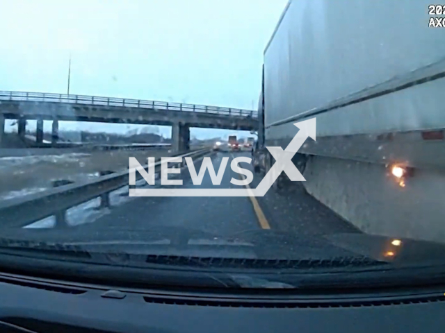 Truck driver closes in on a police officer on a highway in Ontario, Canada, in undated footage. The truck driver failed to check his blind spot, and almost crashed into the police officer. Note: Picture is a screenshot from a video (Ontario Provincial Police)