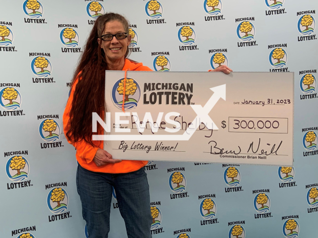 Renae Shelby, 56, poses with her lottery cheque, on Tuesday, Jan. 31, 2023. She bought the winning ticket at Khouris Market, located in Flint, Michigan. Note: Photo from lottery. (Michigan Lottery/Newsflash)