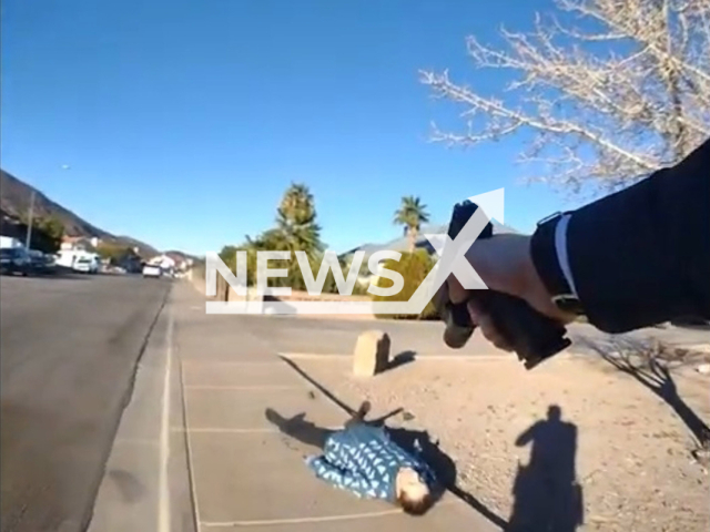 Officer Jordan Hijar aims his gun at a burglary suspect, Ozzie Seeman, 20, on Christmas day, on Sunday, Dec. 25, 2022. The suspect was holding a gun and was shot by officer Jordan. Note: Picture is a screenshot from a video (@HendersonPoliceDepartment/Newsflash)