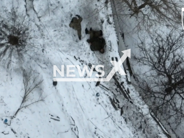 Russian soldier abandons his wounded colleague after attack of Ukrainian drone in a snowy residential area in Ukraine in undated footage. The footage was released by the 103rd brigade of the Ukrainian Territorial Defense Forces on Saturday, Feb. 4, 2023. Note: Picture is a screenshot from a video (@oborona.lviv/Newsflash)