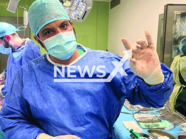 Photo shows Dr Hamad Al-Enezi, holding a bullet, undated. A three-year-old child was hit by a stray bullet in al Jahra, Kuwait. Note: Picture is private (Newsflash)