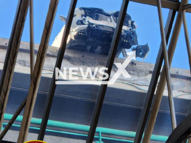 The car  hanging over the edge of the building, in Cambridge, Massachusetts, USA,  on Saturday, Feb. 4, 2023. 
 A  car crashed into a barrier on the top floor of the parking garage, sending concrete debris crashing through a glass ceiling at the  MBTA station.
 Note: Firefighters  photo. (@CambridgeMAFire/Newsflash)