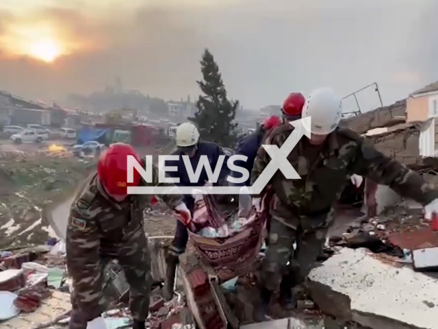 The emergency crew from the Ministry of Emergency Situations of the Republic of Azerbaijan pulling bodies from the rubble and looking for survivors after the earthquake in  Kahramanmaras, Turkey, undated.  The collapse of more than 5000 buildings have been confirmed. Note: Picture is screenshot from a video. (Ministry of Emergency Situations/Newsflash)