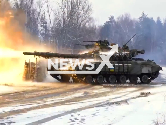 Ukrainian tank fire during a combat exercise at the northern border of Ukraine in undated footage. The footage was released by the Separate presidential brigade on Wednesday, Feb. 8, 2023. Note: This picture is a screenshot from the video. (@Prezydentska.Bryhada/Newsflash)