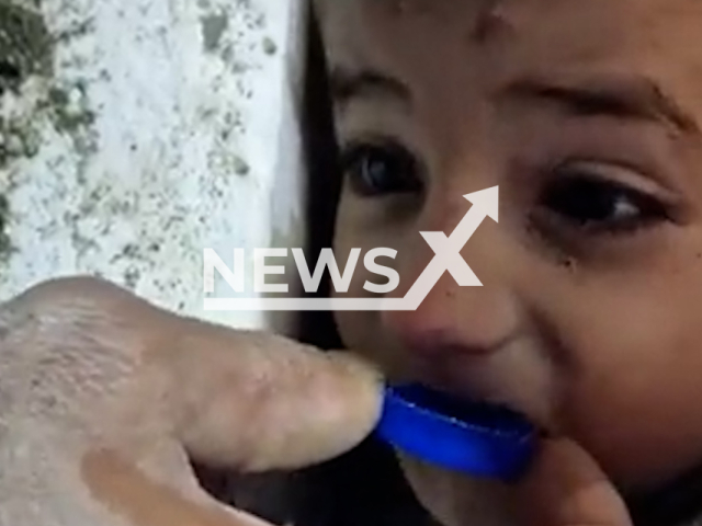 A rescuer gives water to a Syrian boy named Muhammed, who was rescued in Hatay, Turkey, undated. Thousands of people died and were injured as a result of a massive earthquake in Turkey, Monday, Feb. 6, 2023.Note: Picture is screenshot from a video. (Istanbul Metropolitan Municipality/Newsflash)