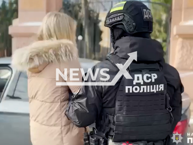 Ukrainian police detain a criminal woman helping conscripted men to cross the Ukrainian border for $7,000 in Ukraine in undated footage. The footage was released by the Ukrainian police of the Mykolaiv region on Thursday, Feb. 9, 2023.Note: Picture is a screenshot from a video. (@mk.npu.gov.ua/Newsflash)