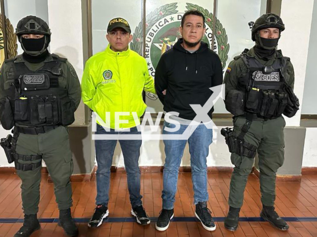 Wilder Emilio Sanchez Farfan, alias Gato Farfan second from the right) poses with police, in undated photo. He was arrested in Pasto, Colombia, it was     reported on Thursday, Feb. 9, 2023. Note: Police photo. (@PoliciaColombia/Newsflash)