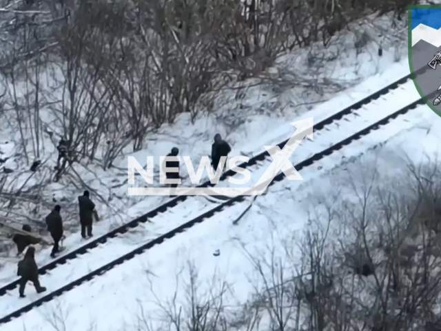 Russian soldiers move down the snowy railway track in Ukraine in undated footage. The footage was released by the 8th battalion of the Ukrainian Ground Forces on Sunday, Feb. 12, 2022. Note: Picture is a screenshot from a video (@8OGSHB/Newsflash)