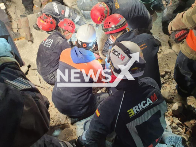 Firefighters and volunteers rescue a 50-year-old woman in Turkey who had been buried under debris for six days after the earthquake, in Turkey. Note: Picture is screenshot from a video. (@112cmadrid/Newsflash)