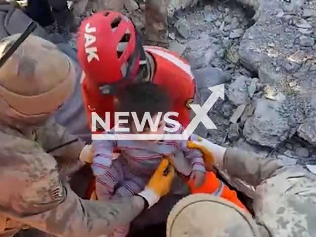 Emergency services rescue a little child in Kahramanmaras, Turkey, in undated footage. Thousands of people have been injured as a result of the earthquake. Note: Picture is screenshot from a video. (@jandarma/Newsflash)