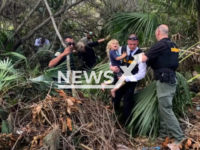 Deputies of the Brevard County Sheriff's Office rescue a missing 4-year-old boy in the woods, in Florida, US, on Friday, Feb. 10, 2023. Frankie, the missing boy, was found unharmed about 60 yards from his home with his loyal dog, Rufus. Note: Picture is from Brevard County Sheriff's Office (Brevard County Sheriff's Office/Newsflash)