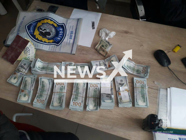 Photo shows dollar bills, undated. Russian search and rescue teams reportedly found USD 150,000 under rubble and handed the money over to the local police. Note: Photo is from the Ministry of Emergency Situations of Russia (@mchs_official/Newsflash)