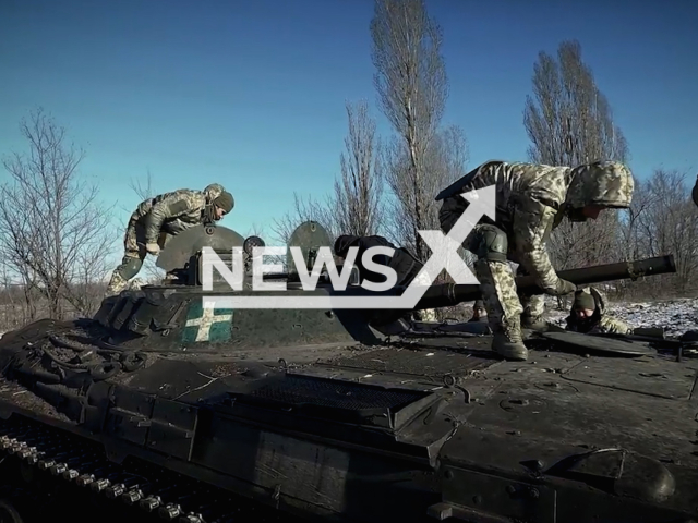 Ukrainian soldiers move parts of the frozen tank in Ukraine in undated footage. The footage was released by the 17th brigade of the Ukrainian Ground Forces on Wednesday, Feb. 15, 2022.Note: Picture is screenshot from a video. (@17otbr/Newsflash)