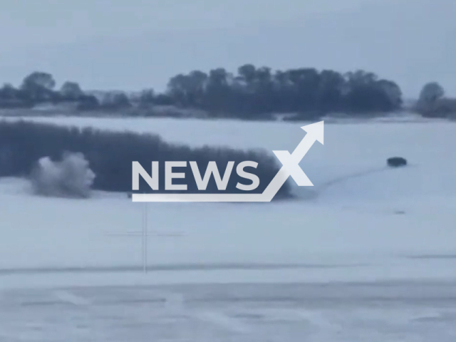 Russian vehicle moves from an explosion at the snowy battlefield in Ukraine in undated footage. The footage was released by the Kharkiv separate territorial defense brigade on Tuesday, Feb. 14, 2022.Note: Picture is screenshot from a video. (@113obr_tro/Newsflash)