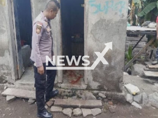 Picture shows a police officer investigating the bathroom where the man cut off his penis, in the Sikka regency, Indonesia, undated. Yohanes Don Bosco,  was reported to be a mental breakdown over child sexual abuse allegations, and  cut off his own penis during a suicide attempt on Saturday, Feb. 11, 2023.
Note: Private photo. (Newsflash)