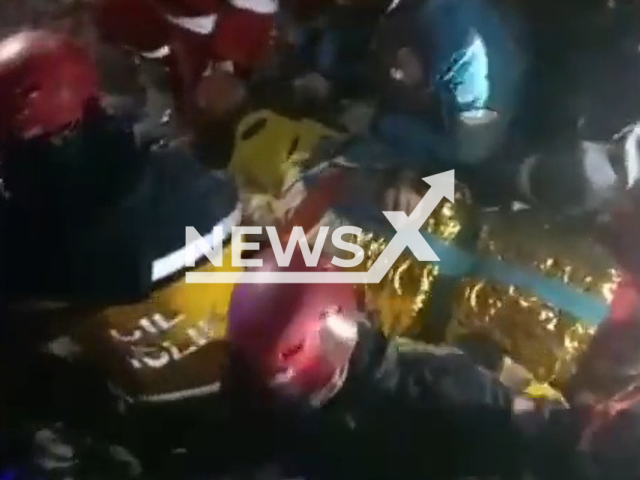 Rescuers pull out Fatma Gunfor, 77, from under the rubble in Adiyaman, Turkey, Wednesday, Feb. 15, 2023. Fatma Gungor was rescued 212 hours after an earthquake hit Turkey. Note: Picture is a screenshot from a video (@tcsavunma/Newsflash)