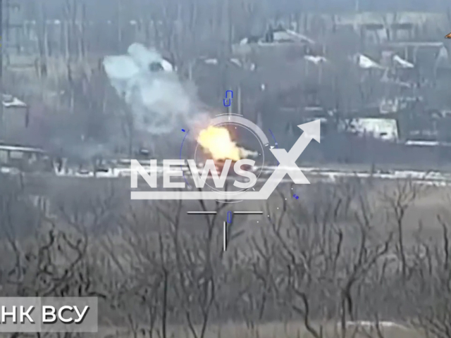 Ukrainian tank burns on the road in a residential area in Ukraine in undated footage. The footage was released by the People's Militia of the DPR on Friday, Feb. 17, 2022. Note: Picture is a screenshot from a video (@nm_dnr/Newsflash)