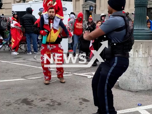 This picture shows a police officer joining the celebration as their national American football team takes home the Super Bowl Trophy in Kansas City, Missouri, undated. The championship parade caused streets all over Missouri, USA, to be crowded with overjoyed fans for a wild celebration. Note: Picture is screenshot from a video. (@kcpolice/Newsflash)