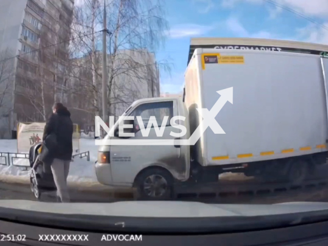 A father throws his son onto the snow in Zelenograd, Moscow, Russia, undated. The father reportedly throw the boy onto the snow because he fell on a puddle. Note: Picture is a screenshot from a video (Newsflash)