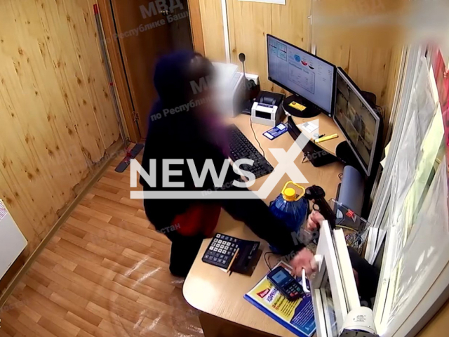 An employee of the gas station, 63, closes the window with a hand of a robber, 27, in Bashkortostan, Russia on Tuesday, Feb. 14, 2023. The robber had a toy pistol. Note: Picture is screenshot from a video. (@mvdporespublikebashkortostan/Newsflash)