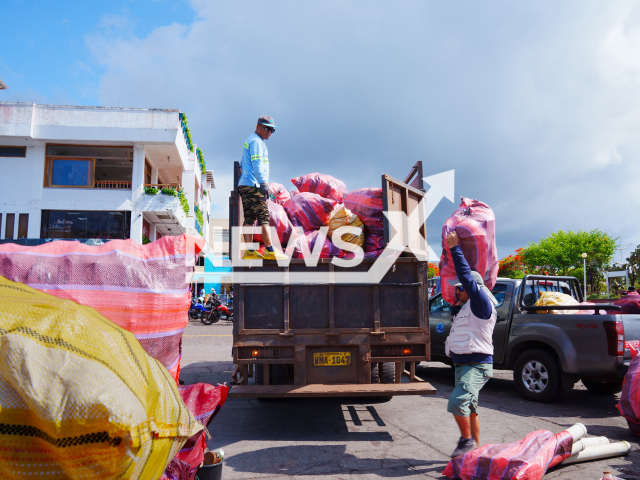 Workers and  volunteers pick up trash during  the first coastal clean-up, in Galapagos, Ecuador, undated.
 A total of 2.6 tons of waste was recovered from Genovesa, Marchena and Pinta islands.
Note: Licensed photo.  (Parque Nacional Galapagos/Newsflash)