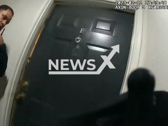 Atlanta Police Department officers stand in front of a door,  in Atlanta, Georgia, on Saturday, Feb. 11, 2023. The officers chased down and arrested a burglary suspect, George Delmar, 49. Note: Picture is a screenshot from a video (@atlantapolicedepartment/Newsflash)