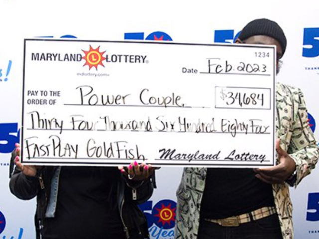 The husband-and-wife team of Lottery players pose with their winning check, undated. The wife said 'There was something calling me to go to the Food Lion' 'It was calling my name'.
Note: Licensed photo.  (Maryland Lottery/Newsflash)