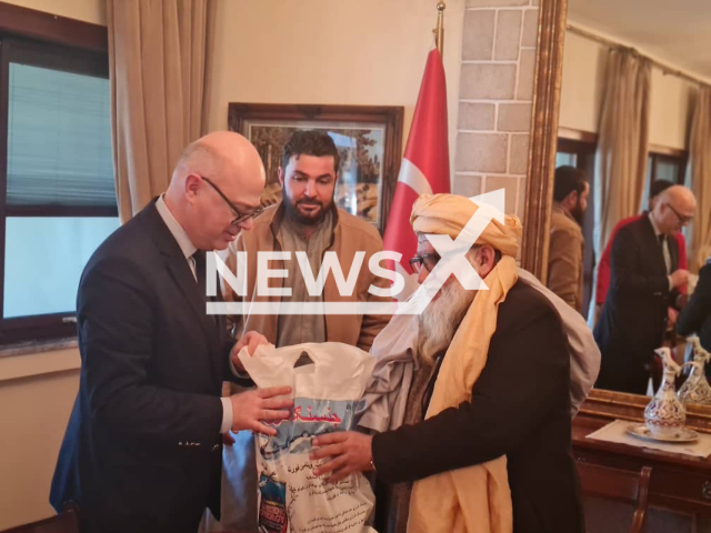 Photo shows Mawlavi Matiul Haq Khalis, the head of the afghan Red Crescent, gives USD 50,000 to to help the earthquake victims in Turkey in a plastic bag, to the ambassador of Ankara in Kabul, undated. The Taliban administration also announced a relief package of USD 110,000 to Turkey. Note: Picture is private (@ARCSAfghanistan/Newsflash)