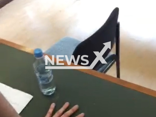 Picture shows the hand of climate activist Henning Jeschke glued to the desk in court in Berlin, Germany, on Tuesday, Feb. 23, 2023.
He glued himself to the table during proceedings.
 Note: Photo is a screenshot from a video. (Newsflash)