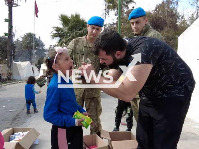 Emergency service employee evaluates earthquake victim in Hatay, Turkey, in undated footage. Thousands of people have been left injured and homeless as a result of the earthquake. Note: Picture is screenshot from a video. (@TCMilliSavunmaBakanligi/Newsflash)