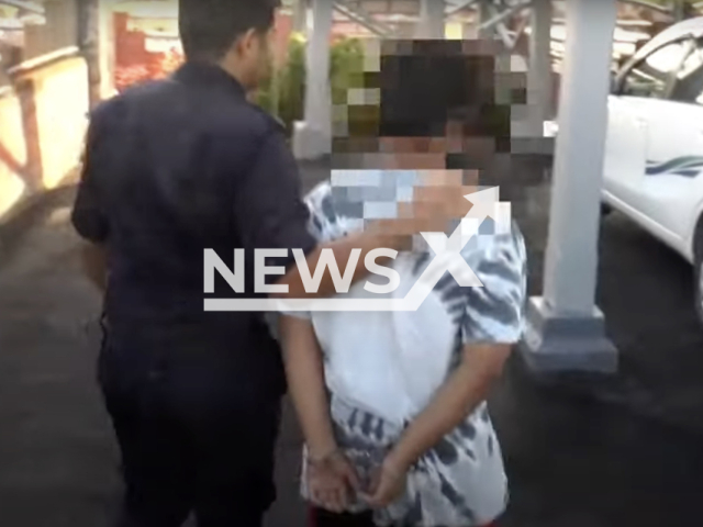 Photo shows a 15-year-old teen with his hands cuffed, undated. He pleaded guilty at the Magistrates’ Court in Malaysia to two counts of committing incest with his younger sister, who eventually gave birth to a baby boy. Note: Picture is a screenshot from a video (Newsflash)