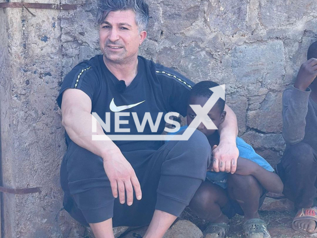 Kursat Yildirim, aged 42, poses with a child in an undated photo. He was spotted in the city of Nairobi, Kenya, in February 2023. Note: Private photo. (@kursat.yildirim40/Newsflash)