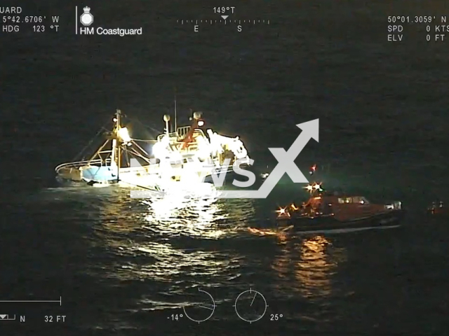 Picture shows two vessels on Tuesday, Feb. 14, 2023. Coastguard rescued four crew members from a fishing vessel that struck rocks at Lands End, in western Cornwall, England. Note: Picture is a screenshot from a video (@MaritimeandCoastguardAgency/Newsflash)