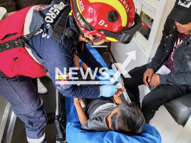 Picture shows firefighter treating the injuries on  the nine-year-old boy, undated. He was rescued  from the jungle after being missing for thirteen days, in Pastaza, Ecuador, on Sunday, Feb. 26, 2023.
Note: Firefighters photo. (@BomberosPuyoEc/Newsflash)