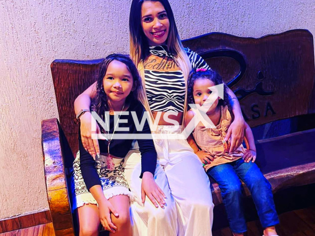 Influencer Amanda, 25,  known as Barbie, poses with unidentified children,  in undated photo. She was shot dead in front of her 5 and 3 year old daughters, in Pernambuco, Brazil.  Note: Private photo.  (@barbie__reserva/Newsflash)