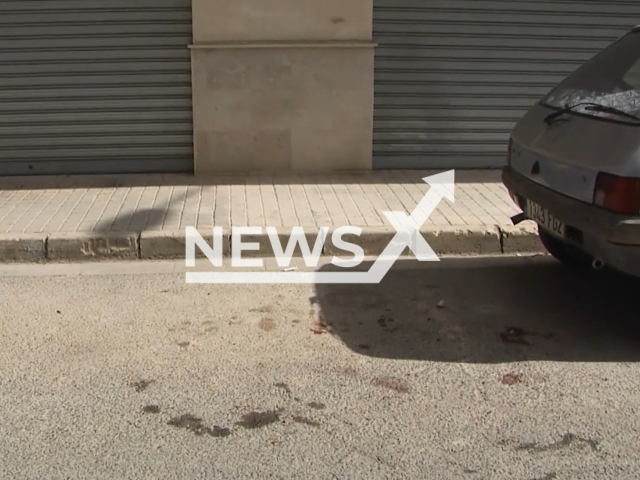 Picture shows blood stains where the mother fell on the street, in Vilamarxant, Spain, undated. She from postpartum depression and slit her baby's throat and committed suicide, on  Monday, Feb.  28, 2023.   
 Note: Photo is a screenshot from a video. (Newsflash)