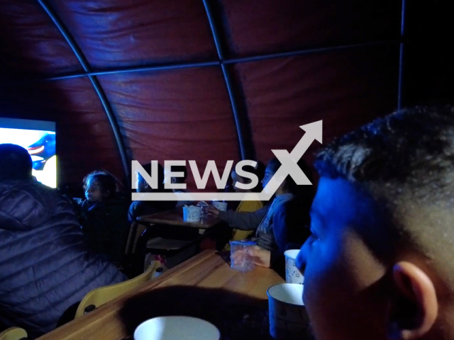 Children, earthquake victims, watch a movie in a tent, in Hatay, Turkey, in undated footage. Thousands of people have been left injured as a result of the earthquake. Note: Picture is screenshot from a video. (@TCMilliSavunmaBakanligi/Newsflash)