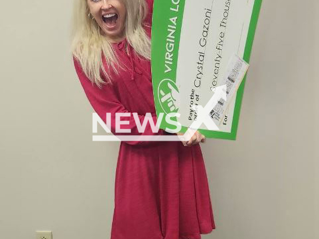 Crystal Holbrook-Gazoni  poses with her with special check for more than USD 75,000 in accumulated winnings. She said that when she bought the ticket, a woman touched her on the shoulder and said, 'Honey, I hope you win big!'. Note: Licensed photo.  (Virginia Lottery/Newsflash)